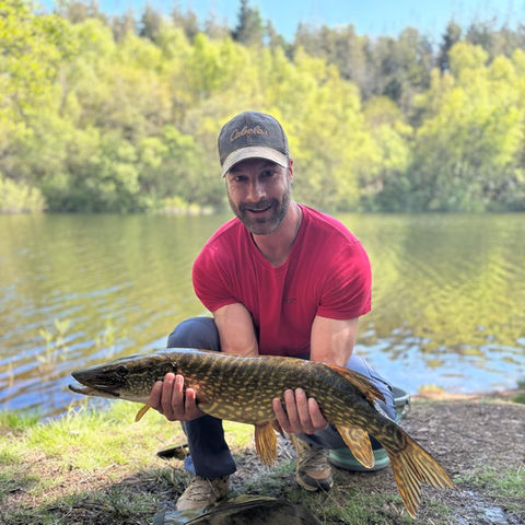 Darren holding a pike caught near Exeter